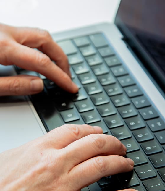 person typing on the laptop